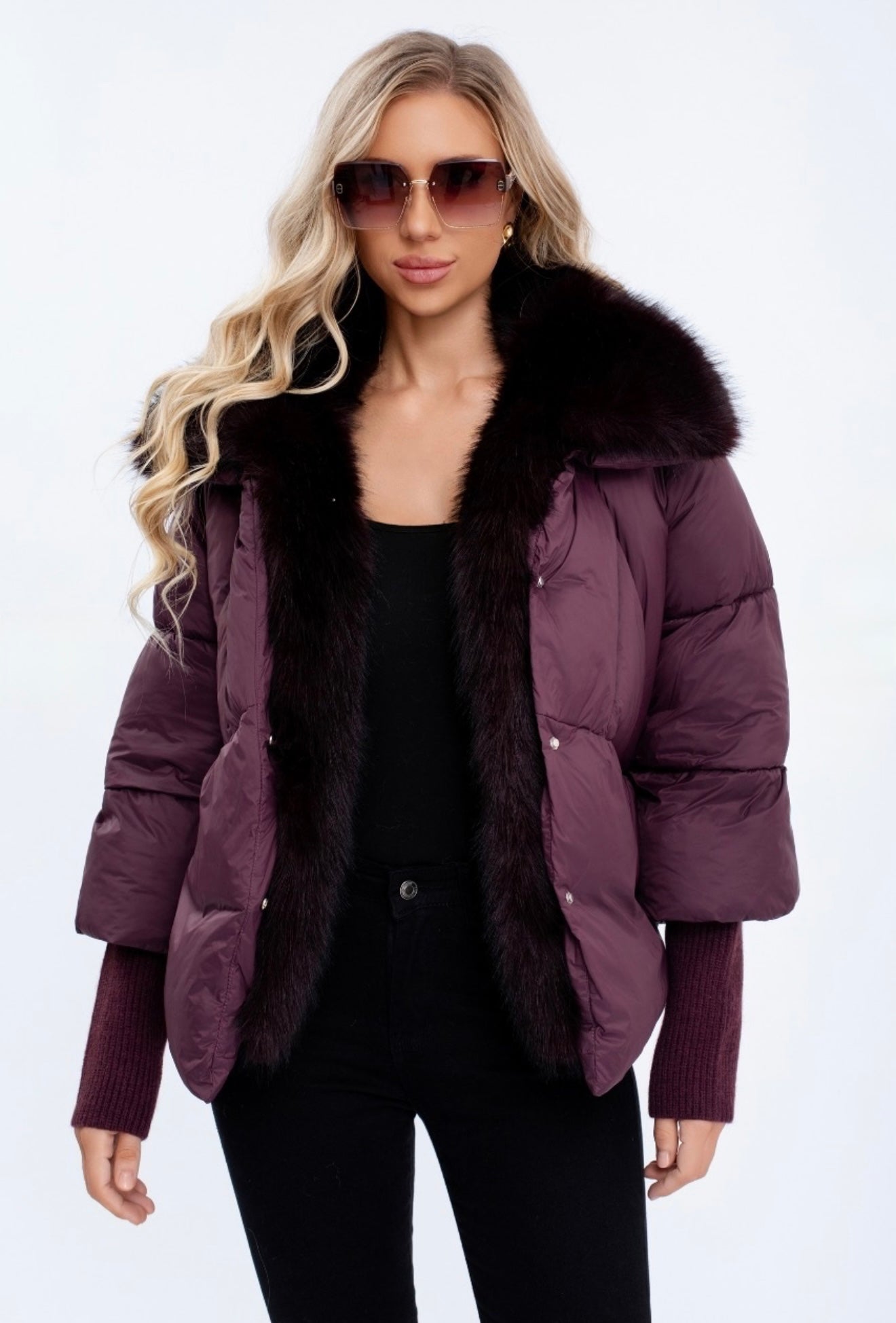 Woman wearing a wine puffer jacket with fur hood 