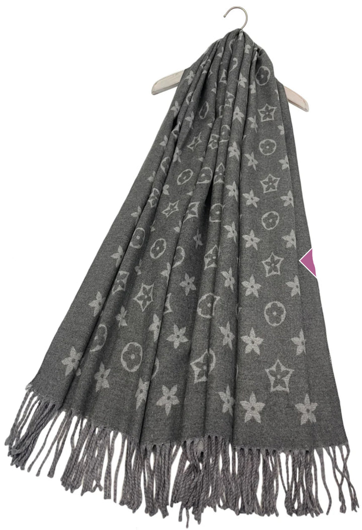 A grey scarf with sparkly metallic thread floral patterns, draped elegantly with a focus on the sparkly details.