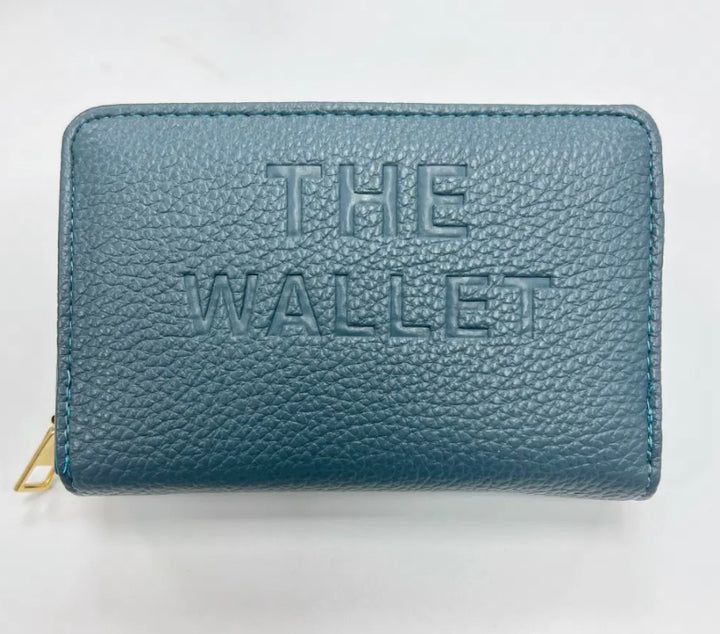 Blue purse with gold hardware and “the wallet” embossed on the front