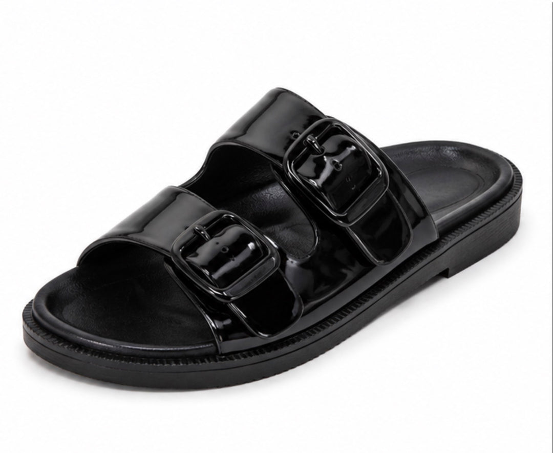 A single black double-strap slide sandal with a glossy patent finish and matching black sole, shown on a plain white background.