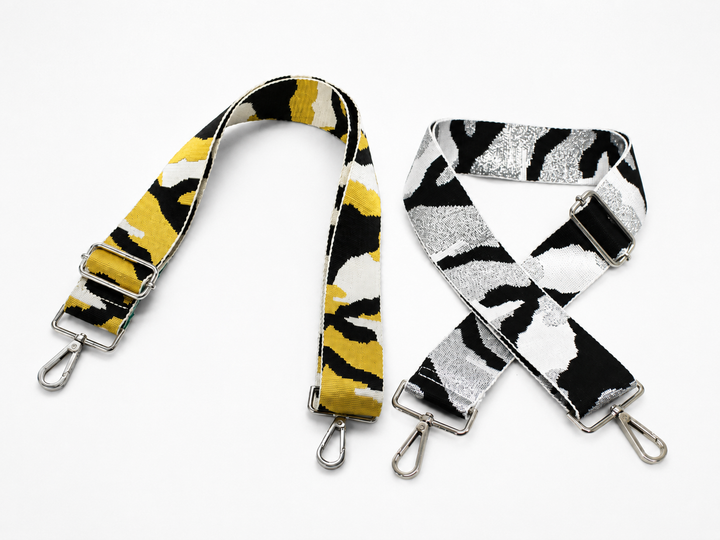 adjustable woven handbag straps featuring a yellow camouflage design and a black, white and metallic silver zebra pattern with silver hardware 