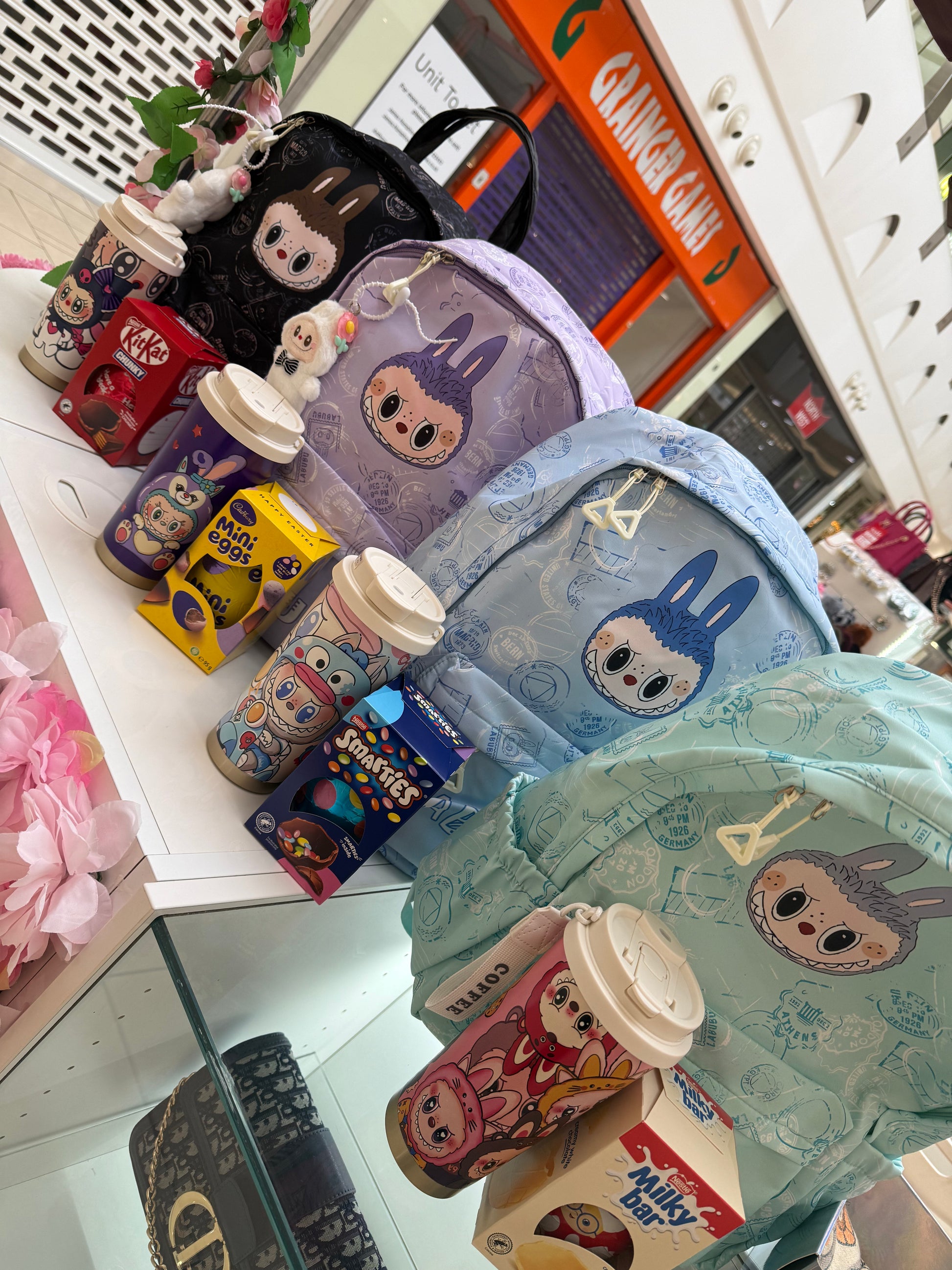 Colourful children’s backpacks with matching water bottle and Easter eggs 