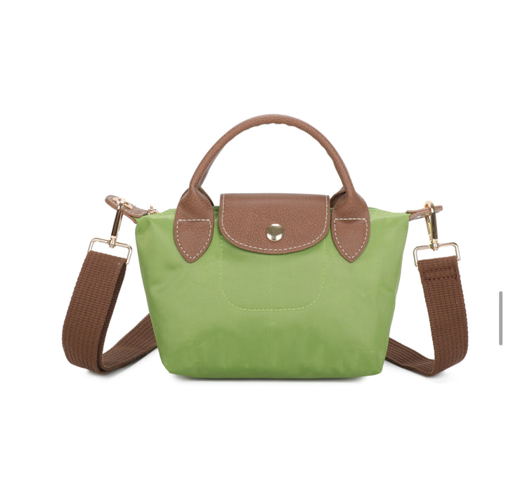 Green handbag with brown handles and strap on a white background