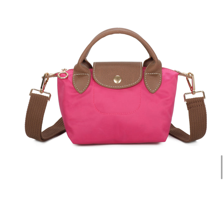Pink handbag with brown handle and strap on a white background