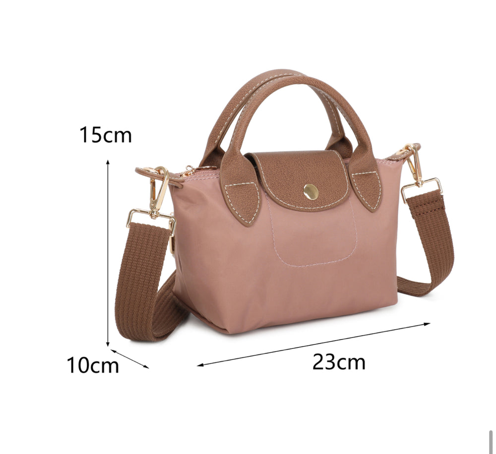 Pink handbag with brown accents on a white background