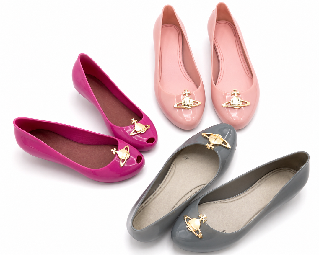 Women’s glossy jelly ballet pumps with gold planet charm detail available in pink, blush pink and grey on a white background.
