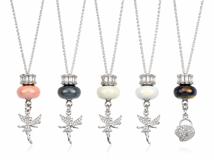 Silver pendant necklace featuring a crystal spacer, decorative bead and fairy or heart charm, available in multiple colours.