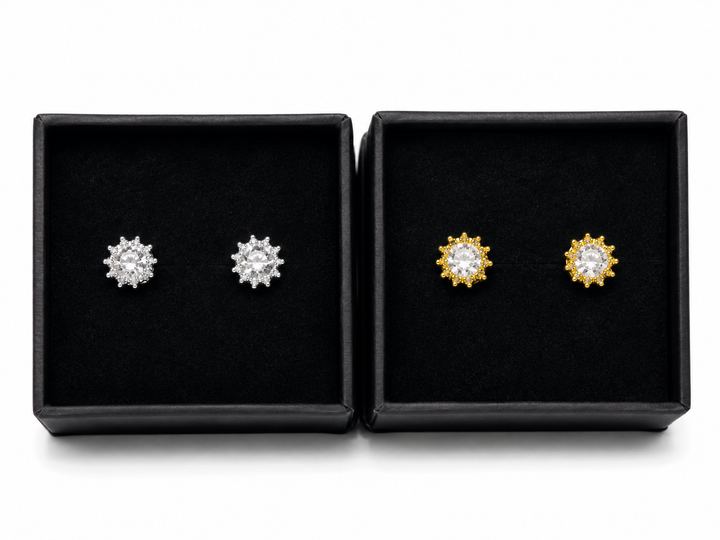 Silver and gold crystal crown stud earrings with sparkling round-cut stones displayed in black jewellery gift boxes.