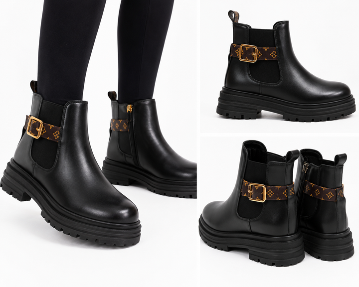Black chunky Chelsea-style ankle boots with brown printed strap, gold buckle and cleated sole