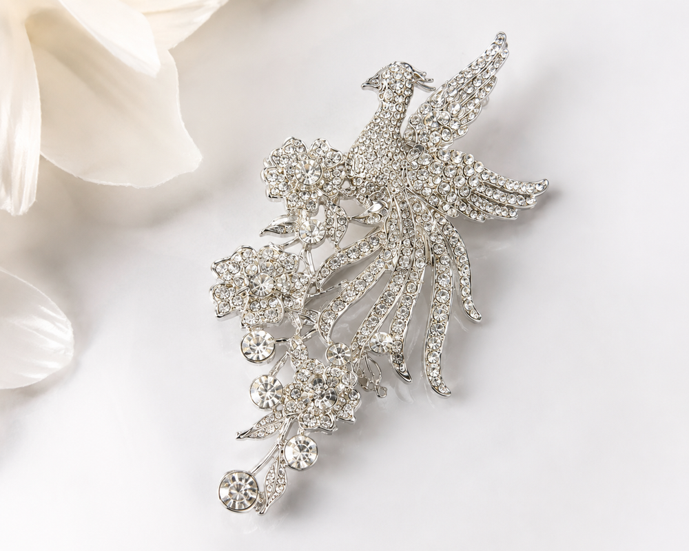 Silver crystal phoenix bird and floral statement brooch with cascading rhinestone detail