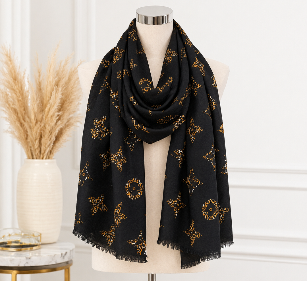 Black oversized statement scarf featuring golden brown leopard-print motifs, delicate fringed edges and soft lightweight fabric