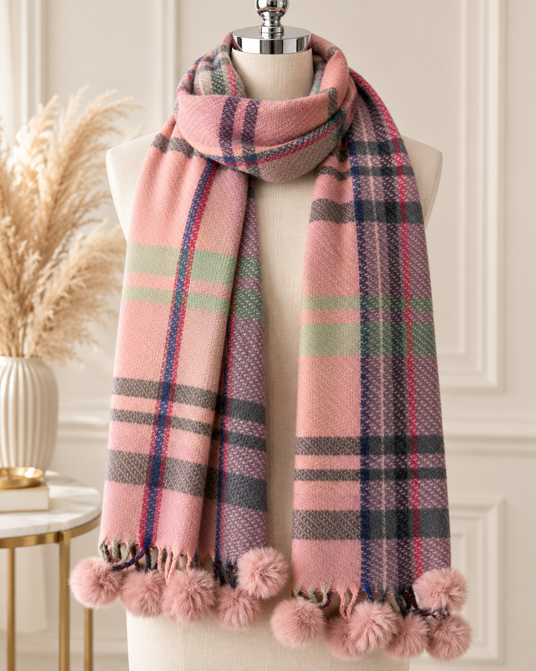 Pink tartan check winter scarf featuring grey, sage green and navy accents with fluffy pink faux fur pom poms