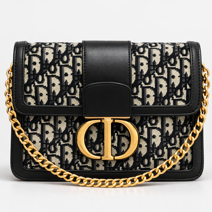 Designer handbag with black and beige pattern and gold chain strap