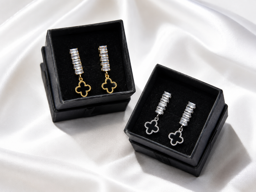 Crystal clover drop earrings with baguette-cut stones in gold and silver