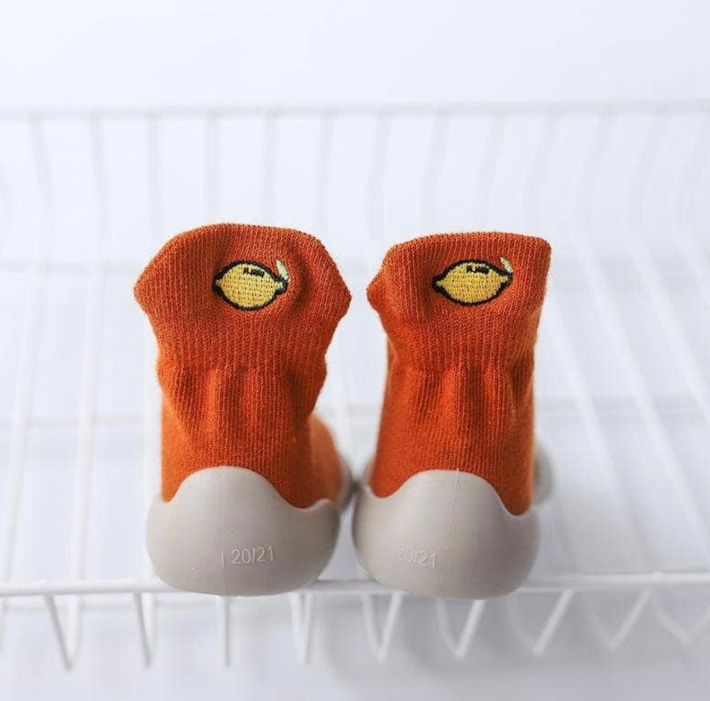 orange sock trainers with stitched lemon detail on the back  