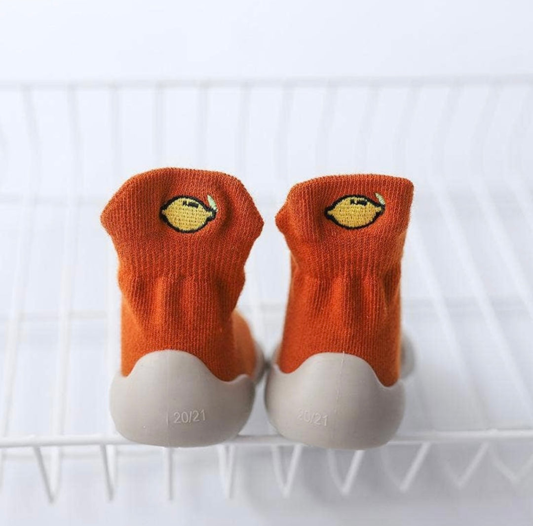 orange sock trainers with stitched lemon detail on the back  