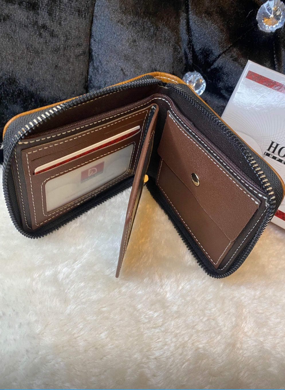 A men’s black and brown detailed wallet