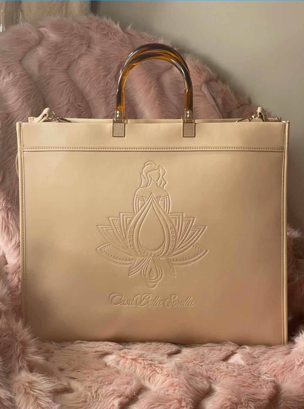 nude faux leather tote bag with the cbs logo on the front