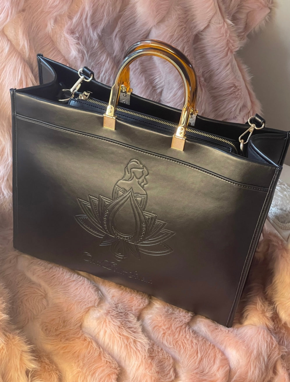 black faux leather tote bag with the cbs logo on the front