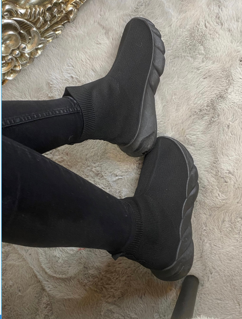 A pair of black sock-style slip on trainers
